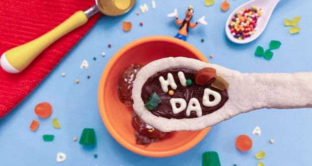 A Goofy Movie-inspired "HI DAD" cookie sits atop ice cream, surrounded by candy and sprinkles at Disneyland Resort.