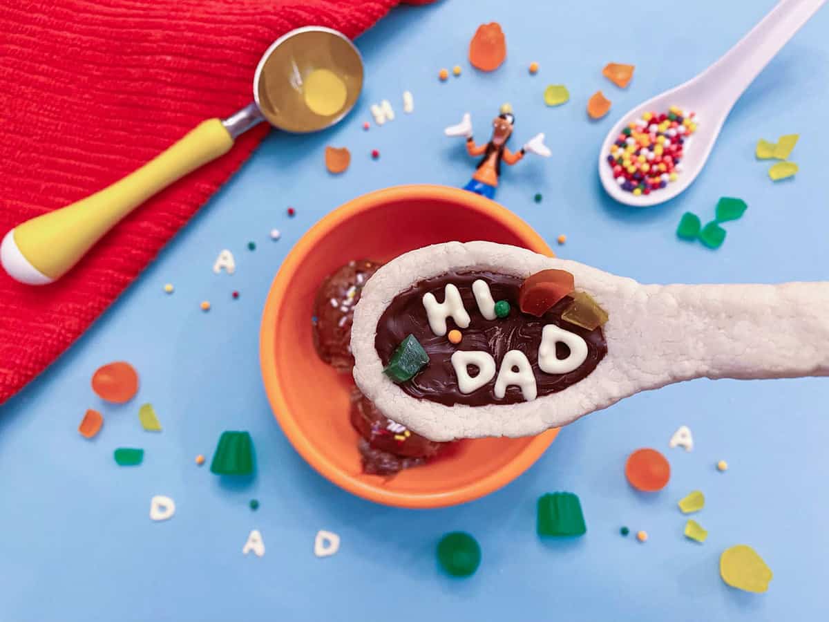 A Goofy Movie-inspired "HI DAD" cookie sits atop ice cream, surrounded by candy and sprinkles at Disneyland Resort.