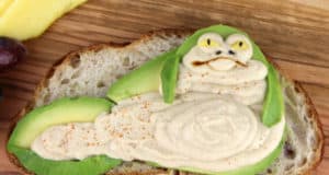 Jabba the Hutt from Star Wars recreated on toast with avocado and hummus—enjoy this galactic snack at your next Star Wars party!.