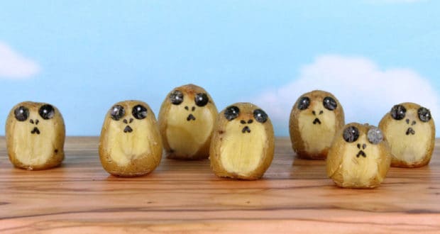 Six Star Wars Porg-inspired potatoes with seaweed faces resemble surprised creatures, perfect for fans at Galaxy’s Edge.