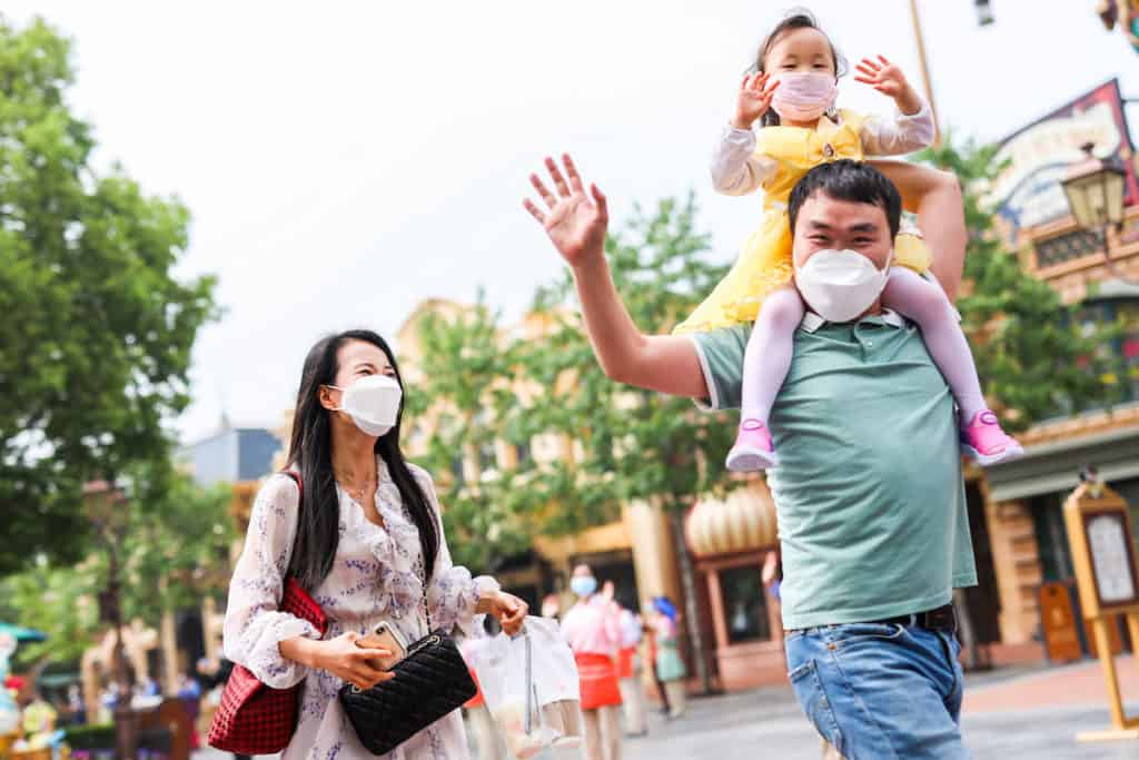 a family walking in shanghai disneyland