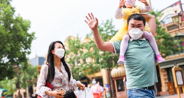a family walking in shanghai disneyland