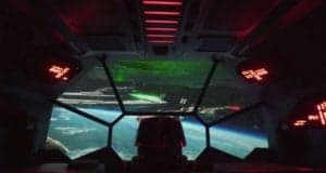 Inside the cockpit on Star Wars: Galaxy’s Edge’s Rise of the Resistance, gazing at space and massive ships with glowing lights.