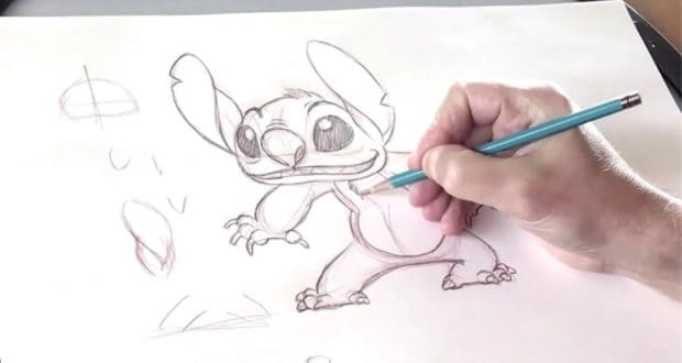 A hand draws Stitch from Disney’s Lilo & Stitch with a pencil on white paper, perfect for Disney fans learning character art.