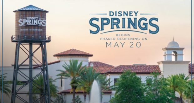 Disney Springs water tower and lively shops, with a sign welcoming guests back for the phased reopening starting May 20.