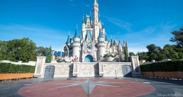 Cinderella Castle’s blue spires gleam under a clear Florida sky, its plaza unusually quiet during DeSantis’s quarantine order.