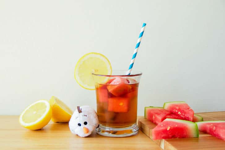 Olaf plush with iced tea, watermelon slices, and Watermelon Ice Cubes at Disney parks—refreshing summer magic!.
