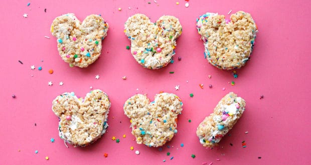 Six Mickey-shaped Rice Krispies treats with colorful sprinkles on pink—just like the magical snacks at Disney Parks!.