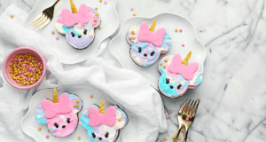 Enchanted unicorn cheesecake bars, sparkling with pink and gold stars, await guests on magical marble plates at Fantasyland.