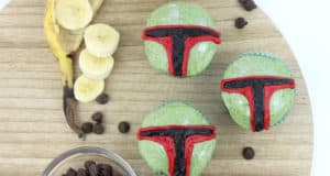 Three green Boba Fett cupcakes with Star Wars-themed red and black details, bananas, and chocolate chips at Galaxy’s Edge.