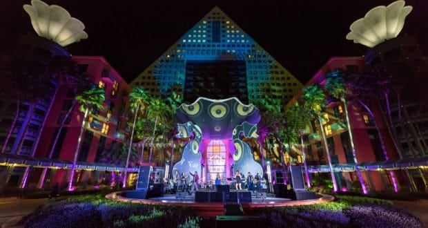 Vibrant stage with live music shines before the Swan & Dolphin hotel at night during the Swan & Dolphin Food & Wine Classic.