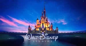 The iconic Disney castle aglow under a twilight sky, with "Walt Disney Studios" text, captures the wonder of Disney parks.