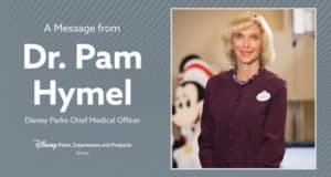Dr. Pamela Hymel beams beside Mickey Mouse, sharing a magical moment at Disney Parks for fans and guests alike.