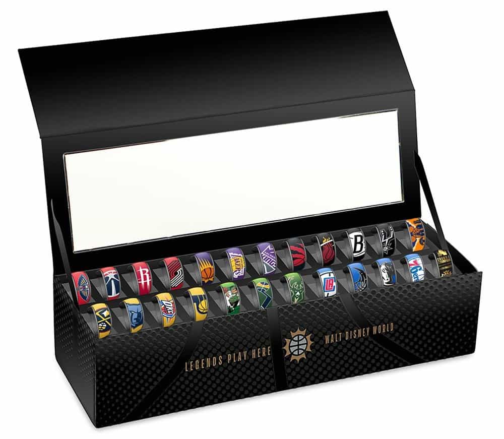 NBA team rings, each with iconic logos and colors, on display at Walt Disney World—an exclusive collectible for MagicBand fans.