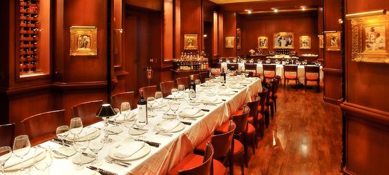 Chic Disney World restaurant by Crescent Lake, long formal tables, wood paneling, and Disney art—top spot for a magical meal.
