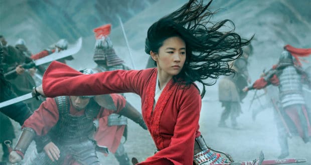 Epic live-action show featuring a heroine in a red robe brandishing a sword, with costumed warriors clashing behind her on stage.