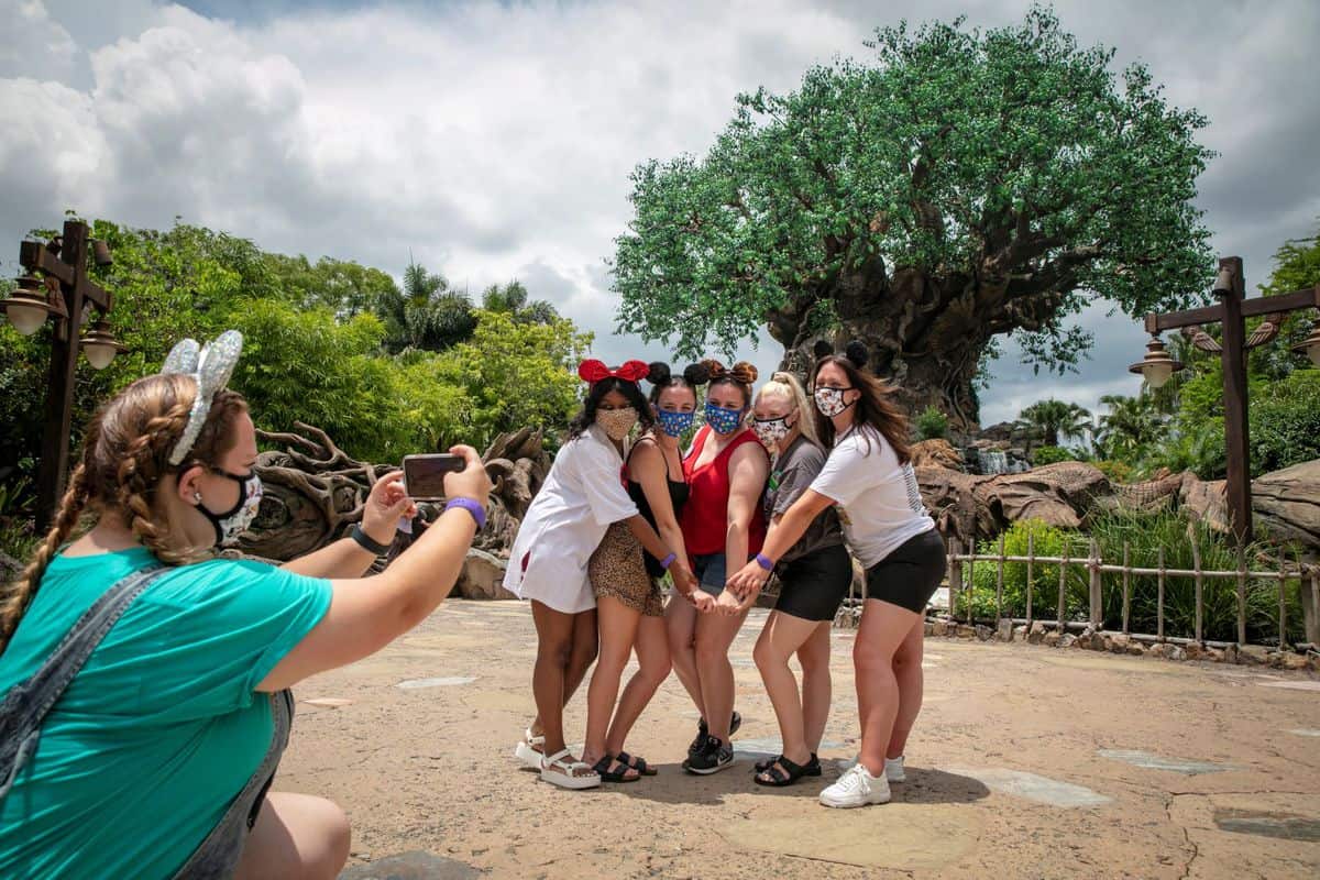 Guests posing in front of Animal Kingdom's tree of life.