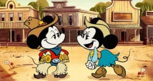 Mickey and Minnie Mouse, featured in The Wonderful World of Mickey Mouse on Disney+, wear cowboy outfits and share big smiles as they greet each other in a lively cartoon Wild West town, capturing the playful spirit fans love at Disney Parks.