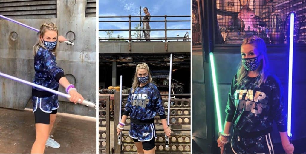 Star Wars fan with Legacy Lightsabers at Galaxy’s Edge, sporting themed sweatshirt and mask for an immersive experience.