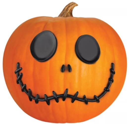 Jack Skellington-inspired pumpkin featuring big black eyes, a petite nose, and a stitched grin, capturing the iconic Nightmare Before Christmas look—an ideal Halloween photo op for fans exploring Disney parks or enjoying special themed events.