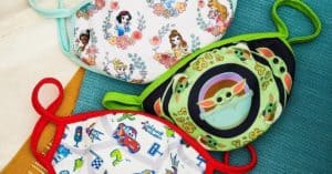 Disney-themed kids’ face masks with vibrant character designs from BoxLunch, perfect for your next magical park adventure, on display.