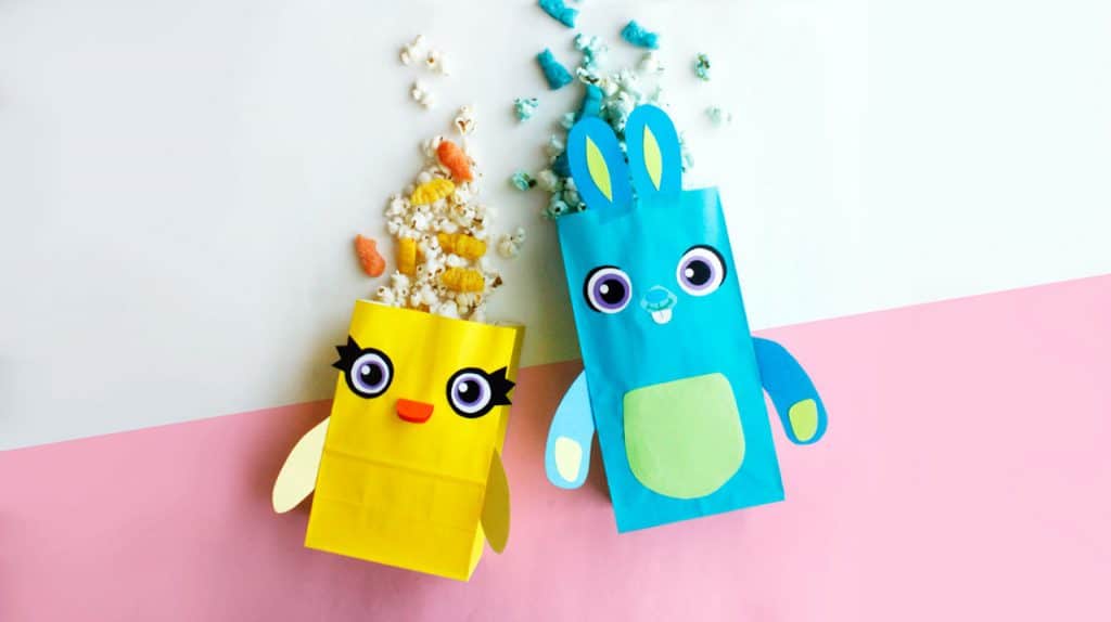 Disney-inspired animal paper popcorn bags spill treats onto a pastel background—ideal for a night of games and Disney magic.