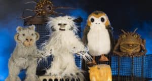 Star Wars fans visiting Disney Springs can check out six incredible creature puppets, featuring favorites like a porg and a wampa, showcased on metal cages against a striking blue backdrop—an exciting addition for any Galaxy’s Edge merchandise collection.