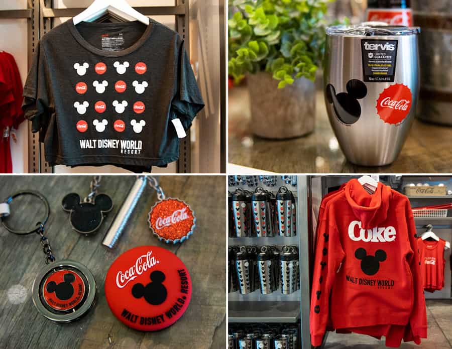 Exclusive Disney Springs display featuring Walt Disney World Resort and Coca-Cola merch, including a themed shirt, collectible tumbler, playful keychains, souvenir buttons, and a bold red sweatshirt.