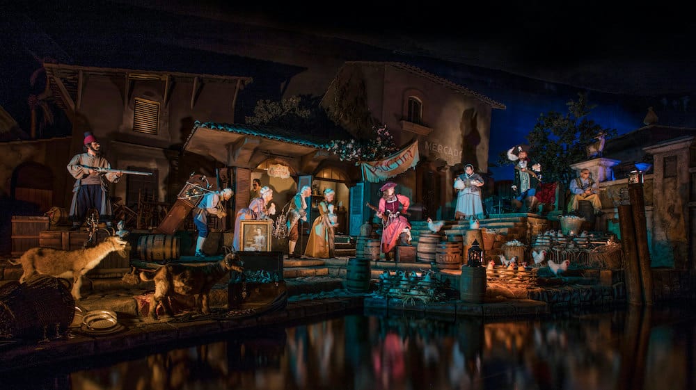 Pirate animatronics bring the bustling Caribbean village scene to life at Disneyland, surrounded by townspeople, animals, and barrels along moonlit waters. This iconic Pirates of the Caribbean setting creates an immersive backdrop for unforgettable pirate-themed photos and swashbuckling fun on Talk Like A Pirate Day.