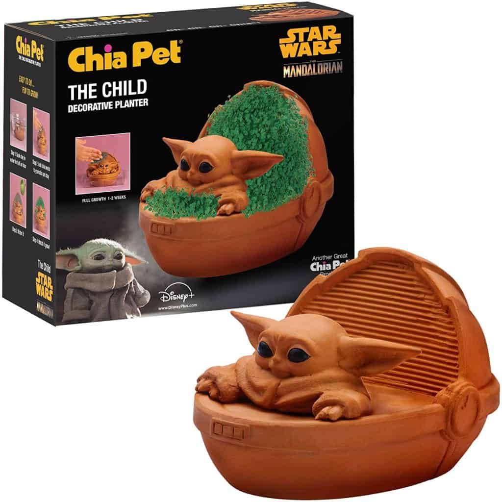 The Mandalorian’s Baby Yoda Chia Pet planter brings a touch of Star Wars magic, featuring lush green sprouts growing from Grogu’s pod and a themed box reminiscent of merchandise found in the galaxy’s most immersive attraction shops.