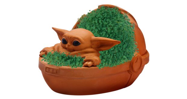 Grogu nestled in his Hover Pram planter, sprouting a lush green layer just like your favorite Chia Pet, ready to bring a touch of Star Wars magic to any Disney Parks souvenir collection.