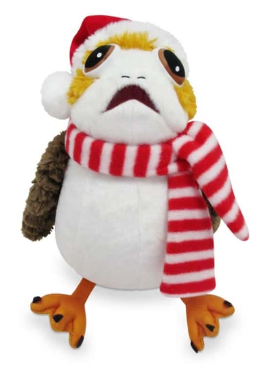 This festive Porg Plush, dressed in a Santa hat and red-and-white striped scarf, gazes up with wide eyes—an irresistible addition for any Star Wars fan celebrating the holidays at Disneyland or Galaxy’s Edge. Bring home the magic of the season with this adorable holiday companion!.