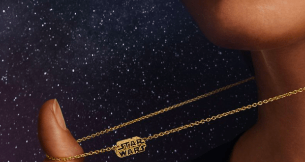 A Star Wars gold necklace from Pandora is displayed against a galaxy-inspired backdrop, with Pandora branding adding to the collectible appeal for fans of themed entertainment.
