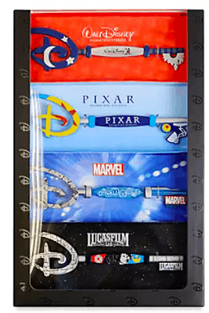 A dazzling set of five Disney collectible keys, featuring icons from Walt Disney, Pixar, Marvel, and Lucasfilm, shines in a sleek black display case—an exclusive Collectable Key Set inspired by the enchantment of the Disney Studio and offered at shopDisney for fans of the ultimate theme park magic.