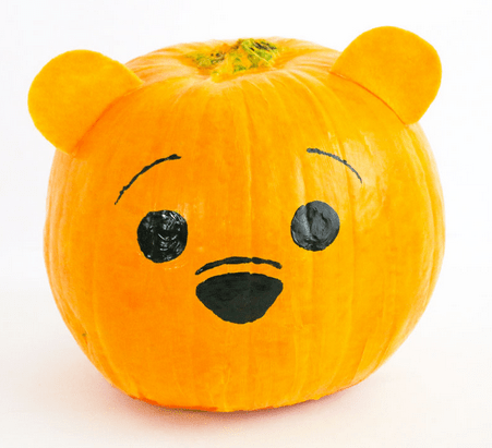 Winnie the Pooh-inspired pumpkin featuring a hand-painted cartoon bear face and attached orange ears, bringing a touch of Hundred Acre Wood charm to your Disney-themed celebration.