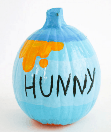 A pumpkin decorated just like Winnie the Pooh’s iconic “Hunny” pot, featuring playful blue paint, dripping orange honey detailing, and “HUNNY” in bold black letters on the front—a whimsical Disney-inspired DIY perfect for fans heading to Mickey’s Not-So-Scary Halloween Party or any Pooh-themed celebration.
