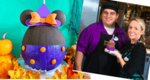 A Halloween Minnie Witch Caramel Apple is showcased at Disneyland Resort, with two happy guests posing together—one holding the festive treat—surrounded by whimsical pumpkin decorations and Halloween-themed décor.