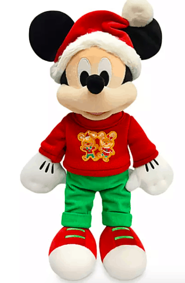 Mickey Mouse dressed for the holidays in a Santa hat, festive red sweater with gingerbread men, green pants, and bright red shoes—an exclusive Disney Parks holiday plush souvenir that captures the magic of seasonal celebrations at Disney World.