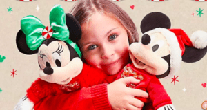 A joyful young guest embraces festive holiday Minnie and Mickey Mouse plushes, surrounded by vibrant seasonal decorations at a Disney Park.
