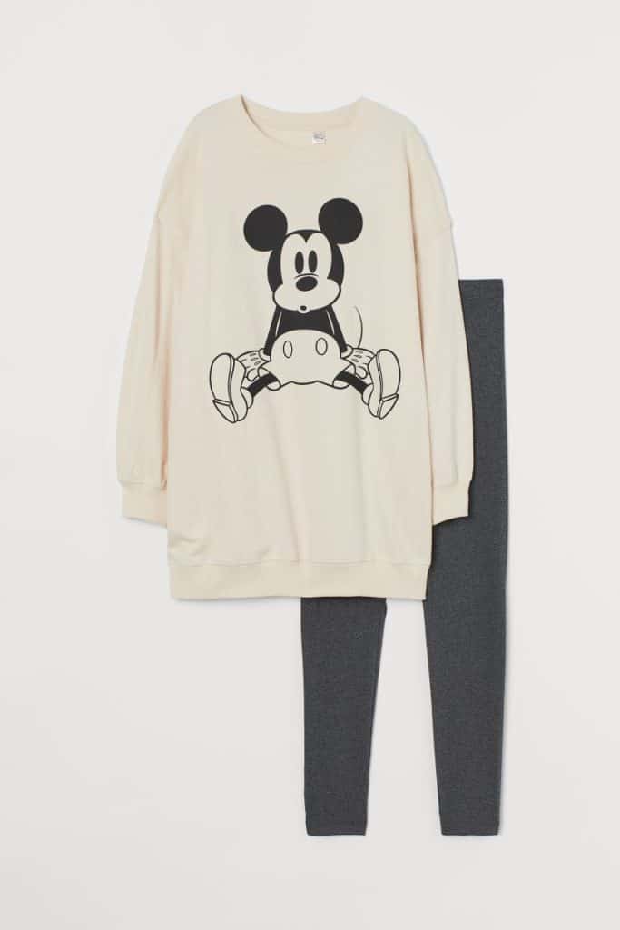 Disney-inspired beige sweatshirt featuring a playful Mickey Mouse print, styled with dark gray leggings and presented flat on a white surface—perfect for fans seeking cozy park-ready outfits.
