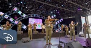 A lively mariachi band energizes the stage with vibrant screens and traditional instruments during a festive Hispanic Heritage Month celebration at Disneyland.