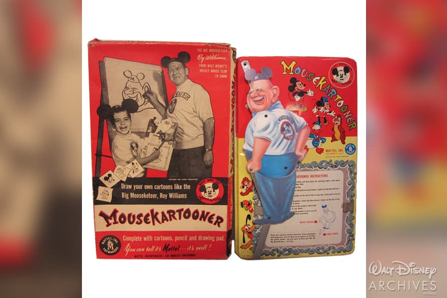 Mousekartooneer drawing kit box showcases Disney legend Roy Williams alongside a young fan, surrounded by classic cartoon artwork and playful text, commemorating 65 years of Mickey Mouse Club magic—a nostalgic celebration of Disney’s creative legacy beloved by theme park guests and fans worldwide.