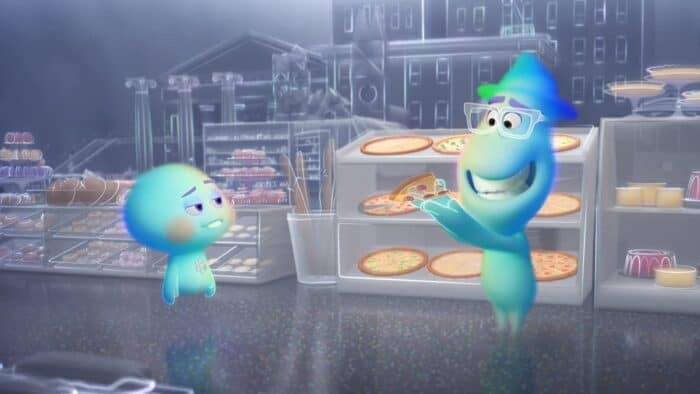 Soul’s glowing blue spirits appear inside a themed pizza restaurant, with one spirit delighting in a slice of pizza while the other—looking unimpressed—seems ready to debate which Disney+ movie should be their next watch, capturing that classic playful energy familiar to Pixar and Disney Park fans.