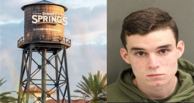 The iconic Disney Springs water tower rises in the background, while a guest sporting a green hoodie and short brown hair enjoys the vibrant atmosphere in the foreground—perfectly capturing the dynamic energy of Disney Springs.