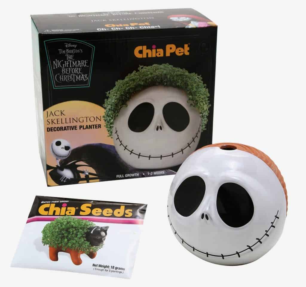 Jack Skellington Chia Pet from The Nightmare Before Christmas, displayed with its branded box and chia seeds packet, showcases a spooky-cool skull planter sprouting vibrant green "hair," adding a whimsical Halloween Town vibe to your holiday decorations—perfect for fans of Disney parks and Tim Burton classics.