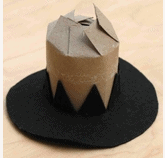 A playful DIY cowboy hat crafted from a cardboard tube and black felt, styled for festive theme park celebrations like Thanksgiving at Frontierland, displayed on a light background.