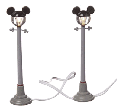 Two gray, streetlamp-inspired lights with round bulbs and classic black Mickey Mouse ears sit connected by a white cord—these delightful lamps bring the whimsical magic of Main Street, U.S.A. to your Mickey’s Christmas Village, creating an enchanting Disney park atmosphere for the holidays.