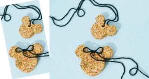 Three bear-shaped cookies decorated with colorful sprinkles and black string bows are displayed on a light blue background—just like the whimsical treats you’d find in the snack shops along Main Street at Disneyland, bringing a sprinkle of magic to your park day or serving as inspiration for adorable Disney-themed party favors.