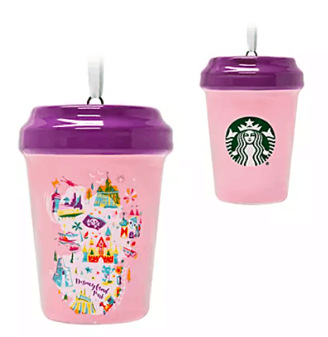 Two pink Starbucks cups with vibrant purple lids—one adorned with playful Disneyland icons and the other sporting the iconic Starbucks logo—bring a touch of Disney magic to your collection. A must-have pair for Disney fans and collectors browsing shopDisney’s exclusive Starbucks Cup Ornaments!.