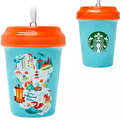 Two blue Starbucks Cup Ornaments with vibrant orange lids, perfect for Disney fans—one showcases the iconic Starbucks logo, while the other captures magical city scenes in colorful illustrations. These collectible ornaments are available exclusively at shopDisney, making them a must-have souvenir for theme park enthusiasts.